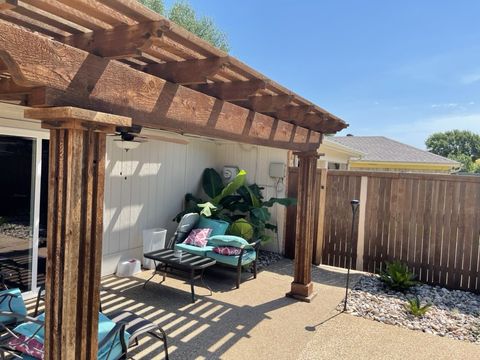 Pergola bed with river rock and tropical planting