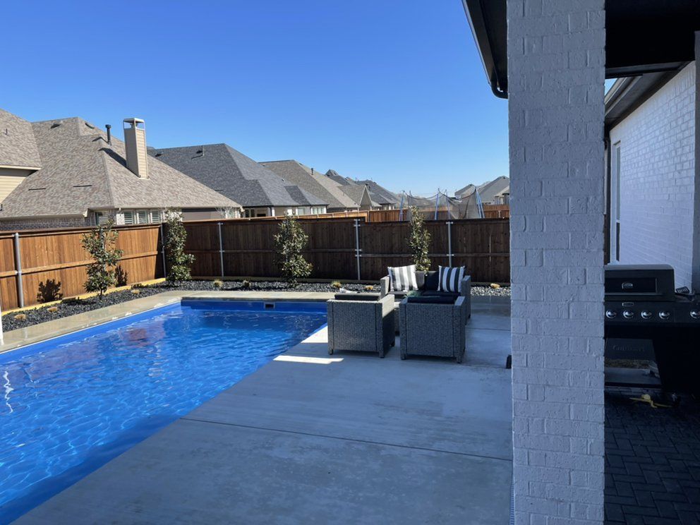 After: pool deck framed by gravel beds and new sod