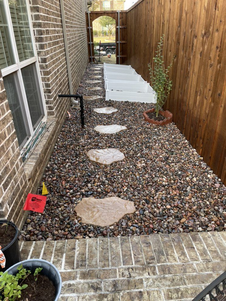After: flagstone step stones in river rock with planter boxes