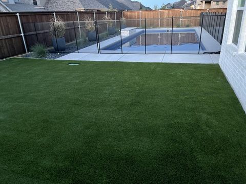 Artificial turf by a pool fence