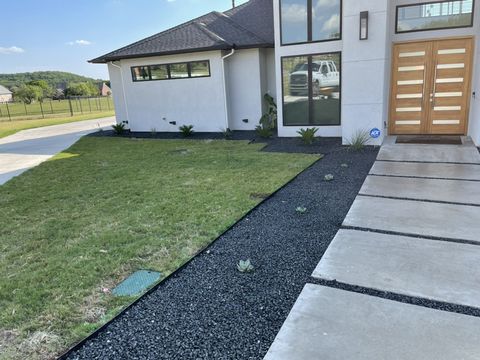Agave and yucca in black gravel along the entry