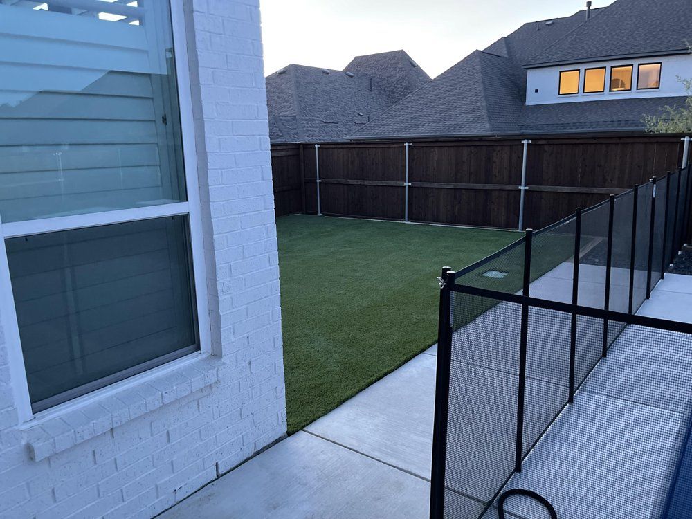 Artificial turf beside a pool fence