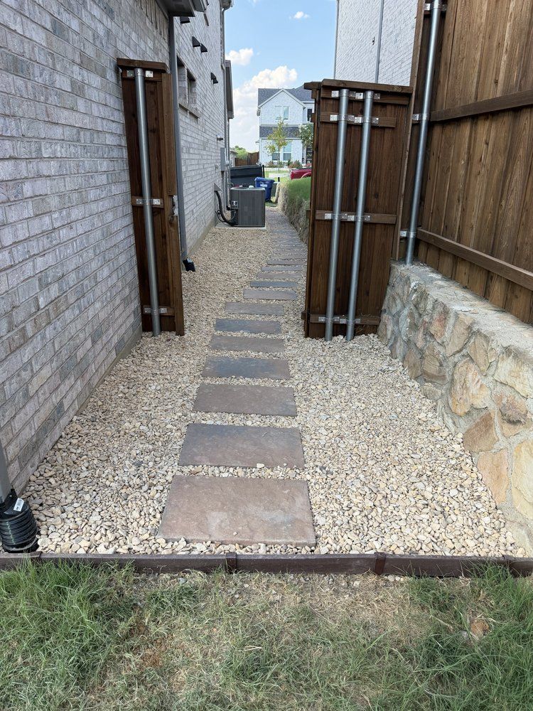Britt Brown 16 by 24 inch pavers set in gravel along a side yard