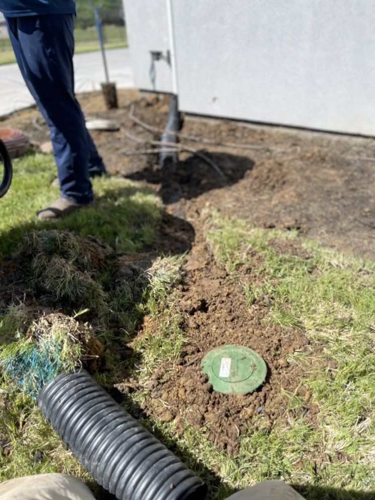 Downspout drain line being trenched into a lawn