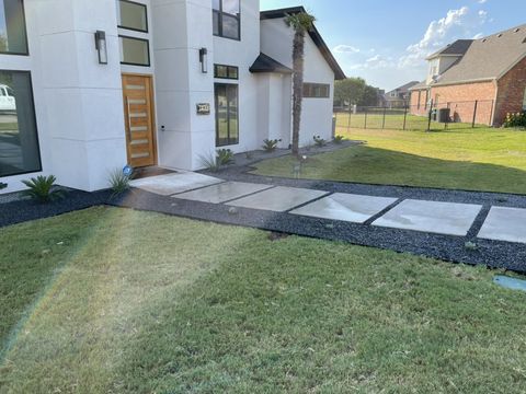 Floating concrete walkway through gravel and sod